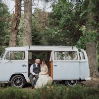 Wedding couple parked in the woods